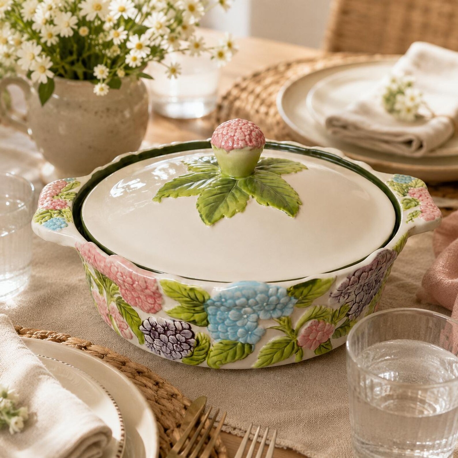 White ceramic casserole dish with raised hand-painted hydrangea flowers and a lid